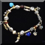 J073. Silver charm bracelet. Some charms signed Misani and Pageo. 7.5” - $28 